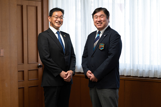 江戸川区庁舎の会議室で、笑顔で写真に収まる斉藤猛さんと吉川禎延さん